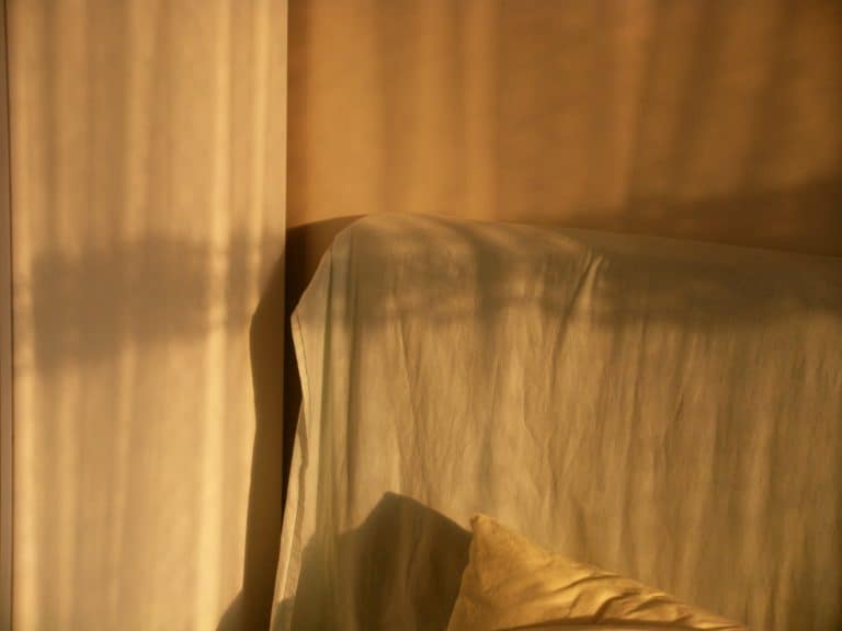 Warm amber light on a bed